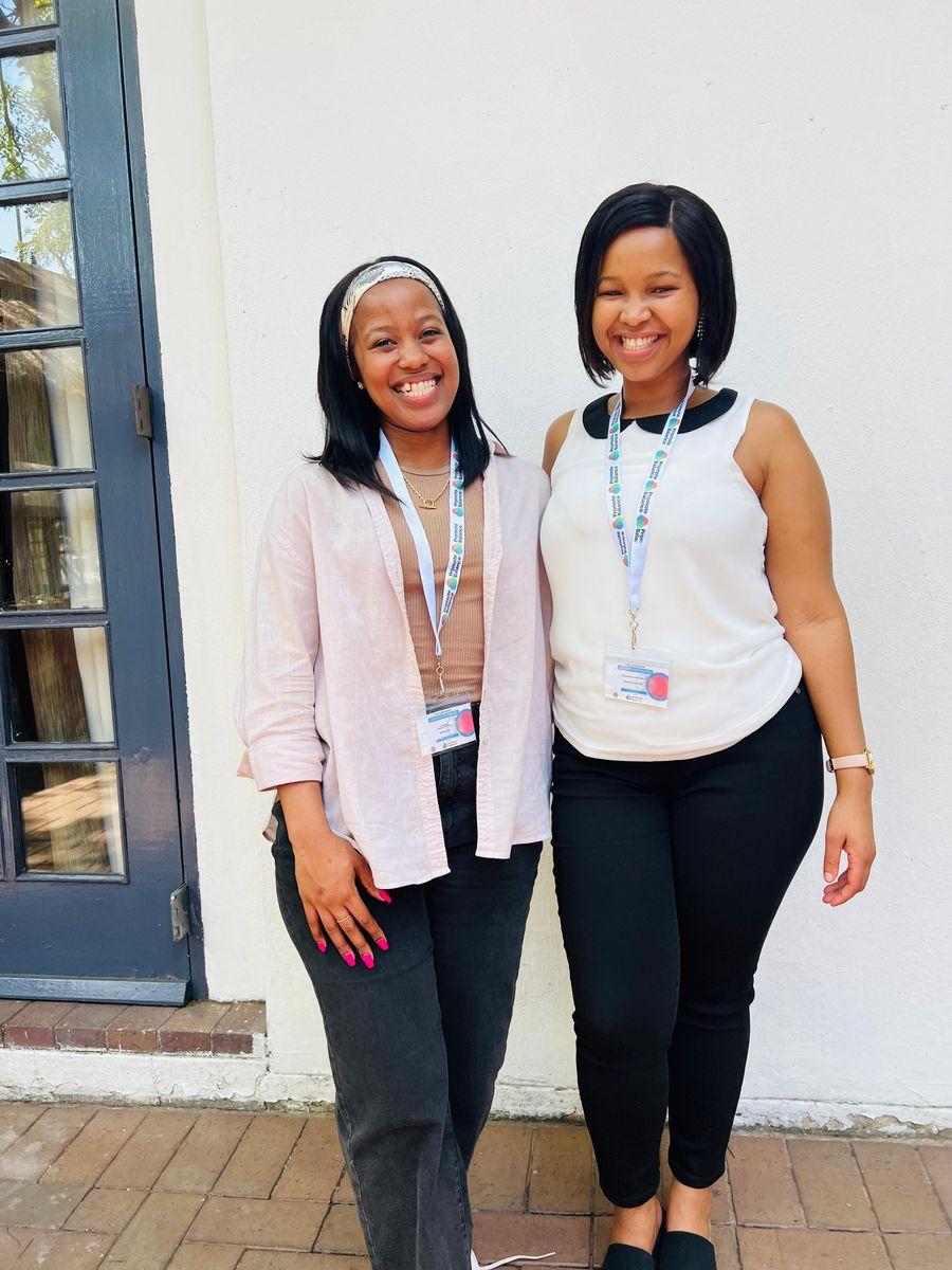 Two delegates wearing their workshop lanyards